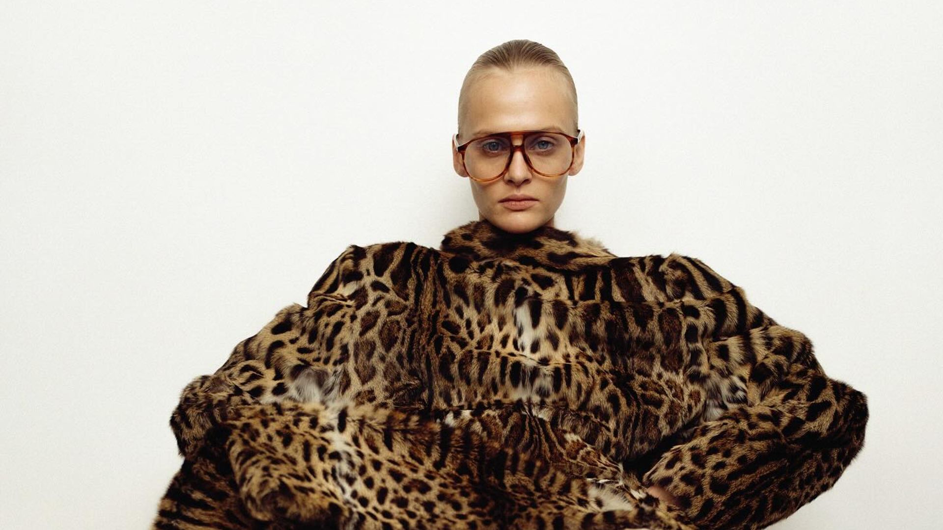Luxury upcycled fur brand Nereja post an image of a model sitting down in a full leopard print outfit