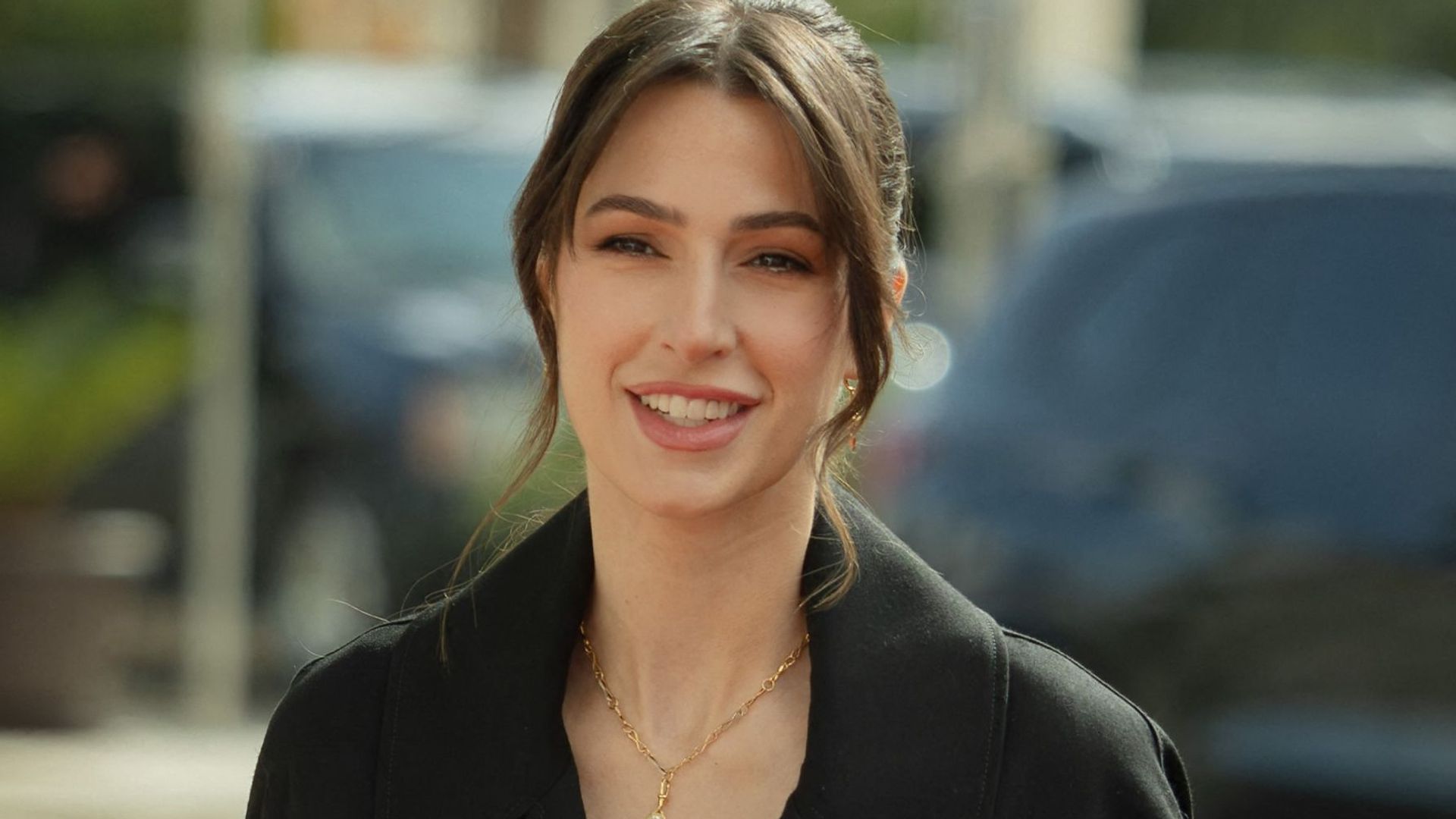 Princess Rajwa in a black coat with her hair up