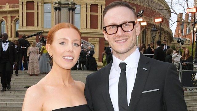 Stacey Dooley and Kevin Clifton posing together at The Olivier Awards 2022