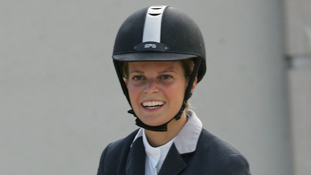 Athina Onassis riding a horse in a competition