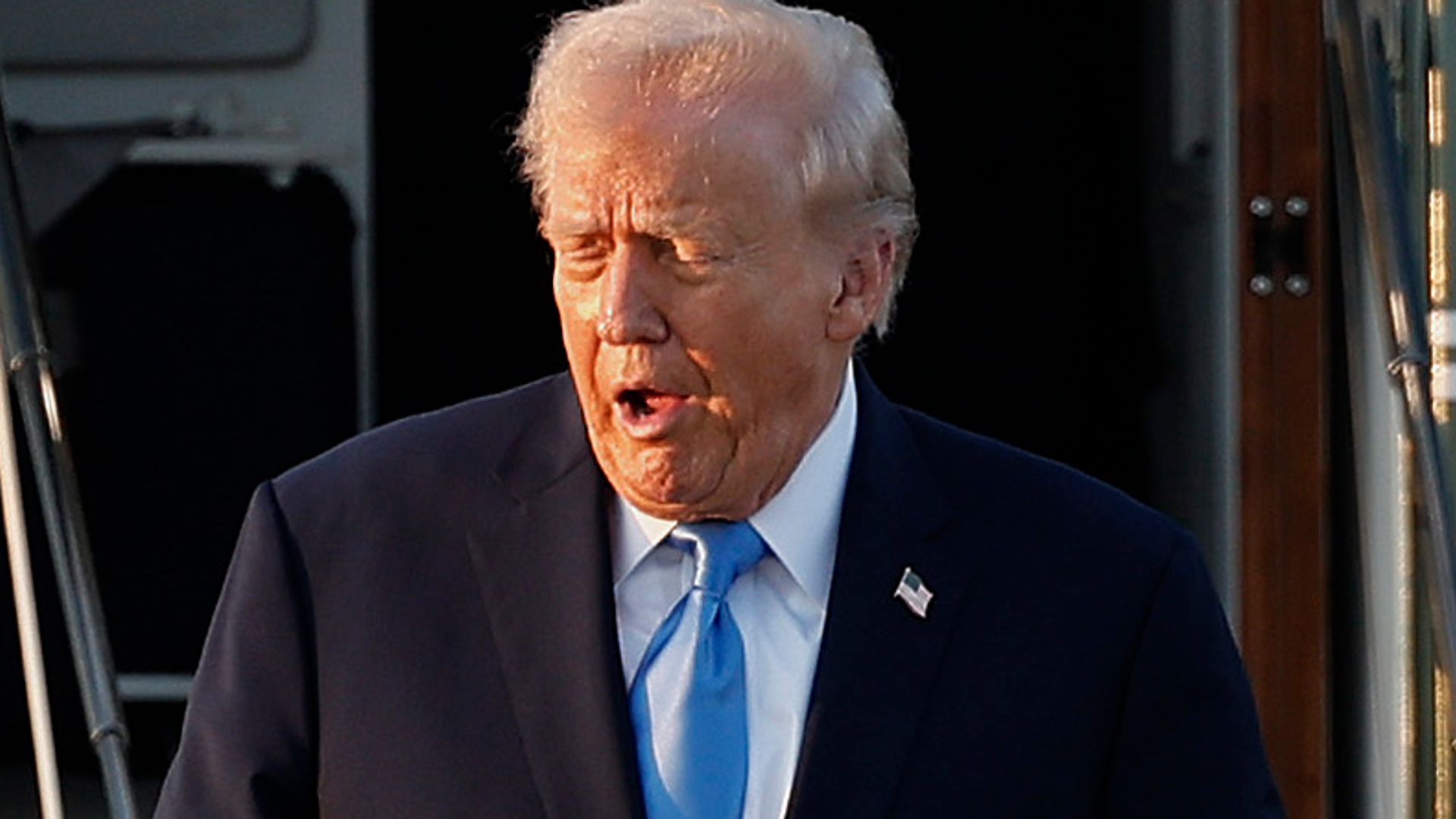 Donald Trump yawning as he exits a helicopter