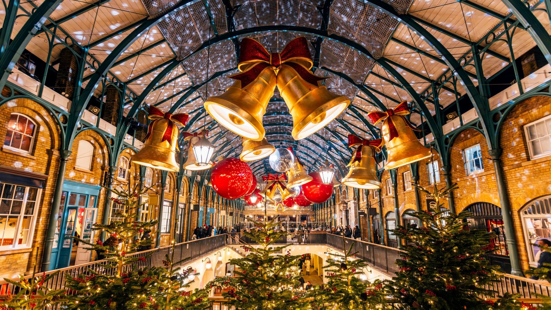 Golden Bells and Christmas lights at Covent Garden Market during Christmas holidays, wide angle view, London, England, UK