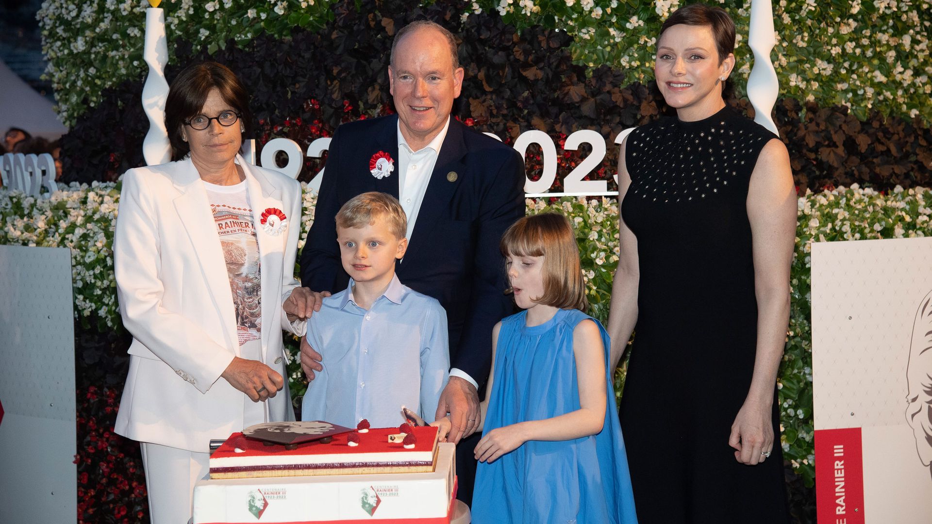 Princess Stephanie, Prince Albert, Princess Charlene, Prince Jacques and Princess Gabriella with a cake