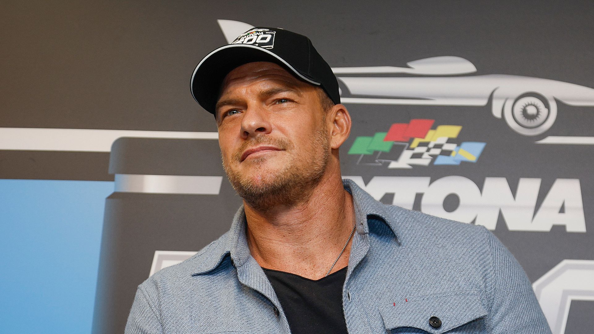 Alan Ritchson speaks to the media during a press conference prior to the NASCAR Cup Series Daytona 500 at Daytona International Speedway on February 16, 2025 in Daytona Beach, Florida