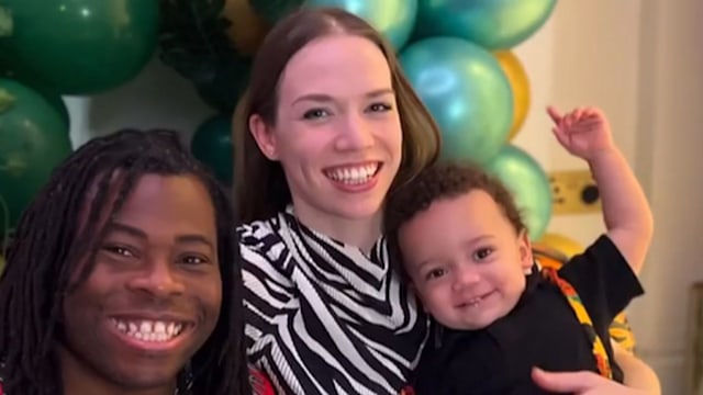 Ade Adepitan and his wife Linda Harrison with their son Bolla in front of several green balloons