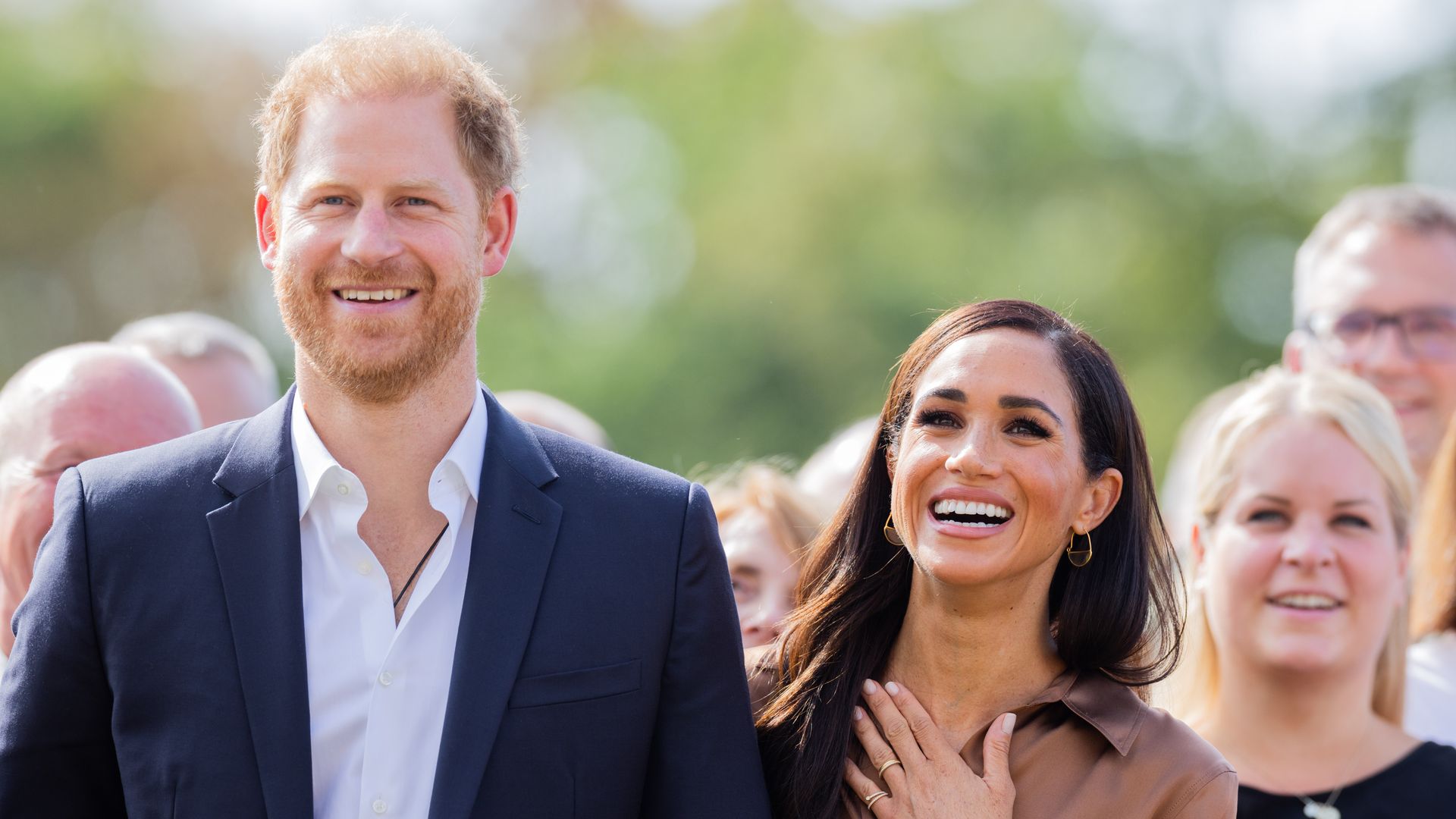 Harry and Meghan smiling at Invictus Games