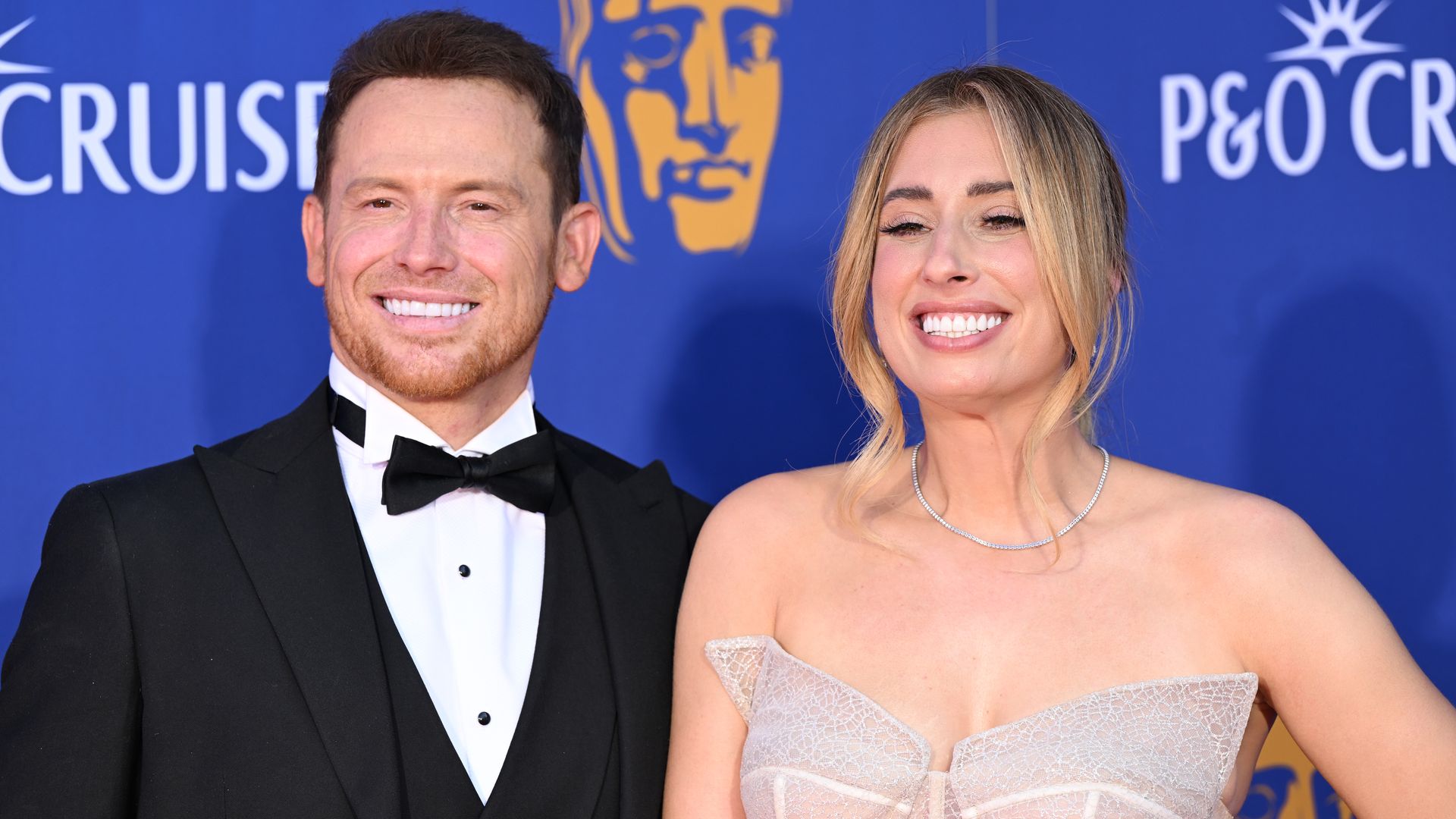 Joe Swash in suit and Stacey Solomon in strapless dress