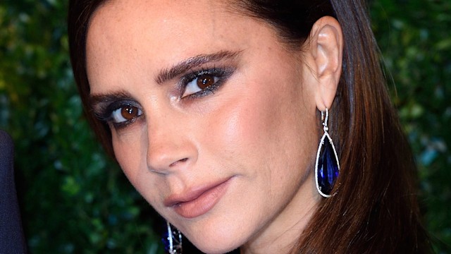 Victoria Beckham wearing navy eyeshadow and drop earrings a she attends the 60th London Evening Standard Theatre Awards at London Palladium in 2014
