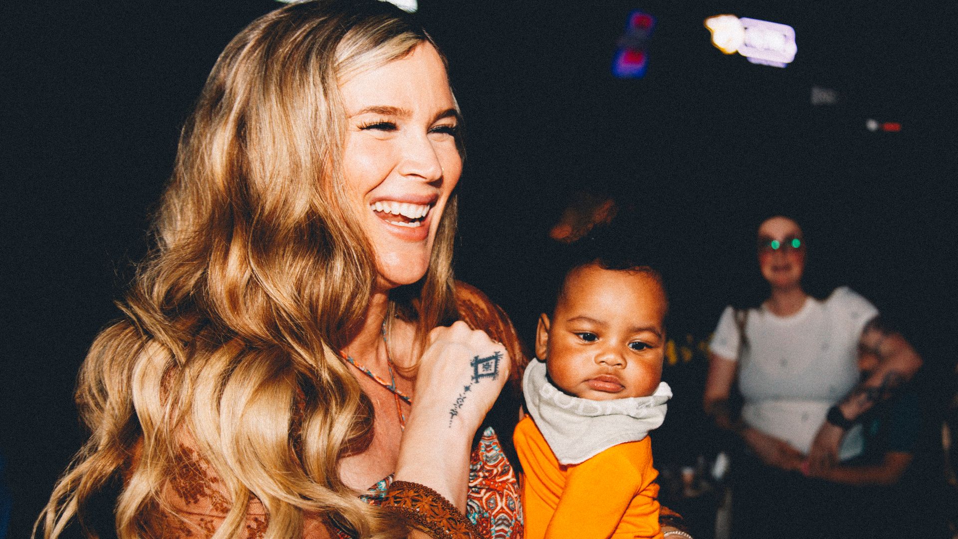 Josss Stone holding baby