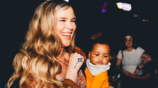 Josss Stone holding baby 