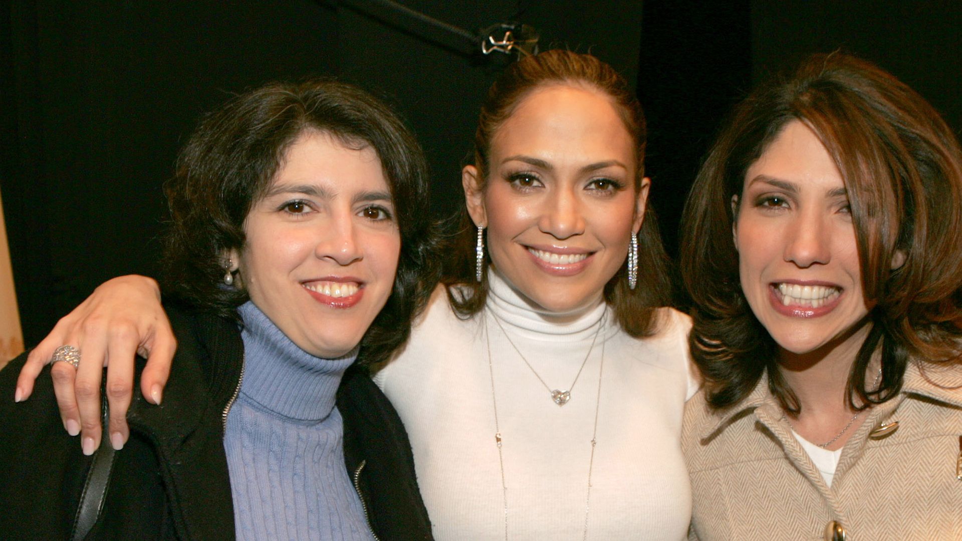 Leslie Lopez wears a blue jumper, Jennifer Lopez wears a cream jumper and Lynda Lopez wears beigeduring Olympus Fashion Week Fall 2005 