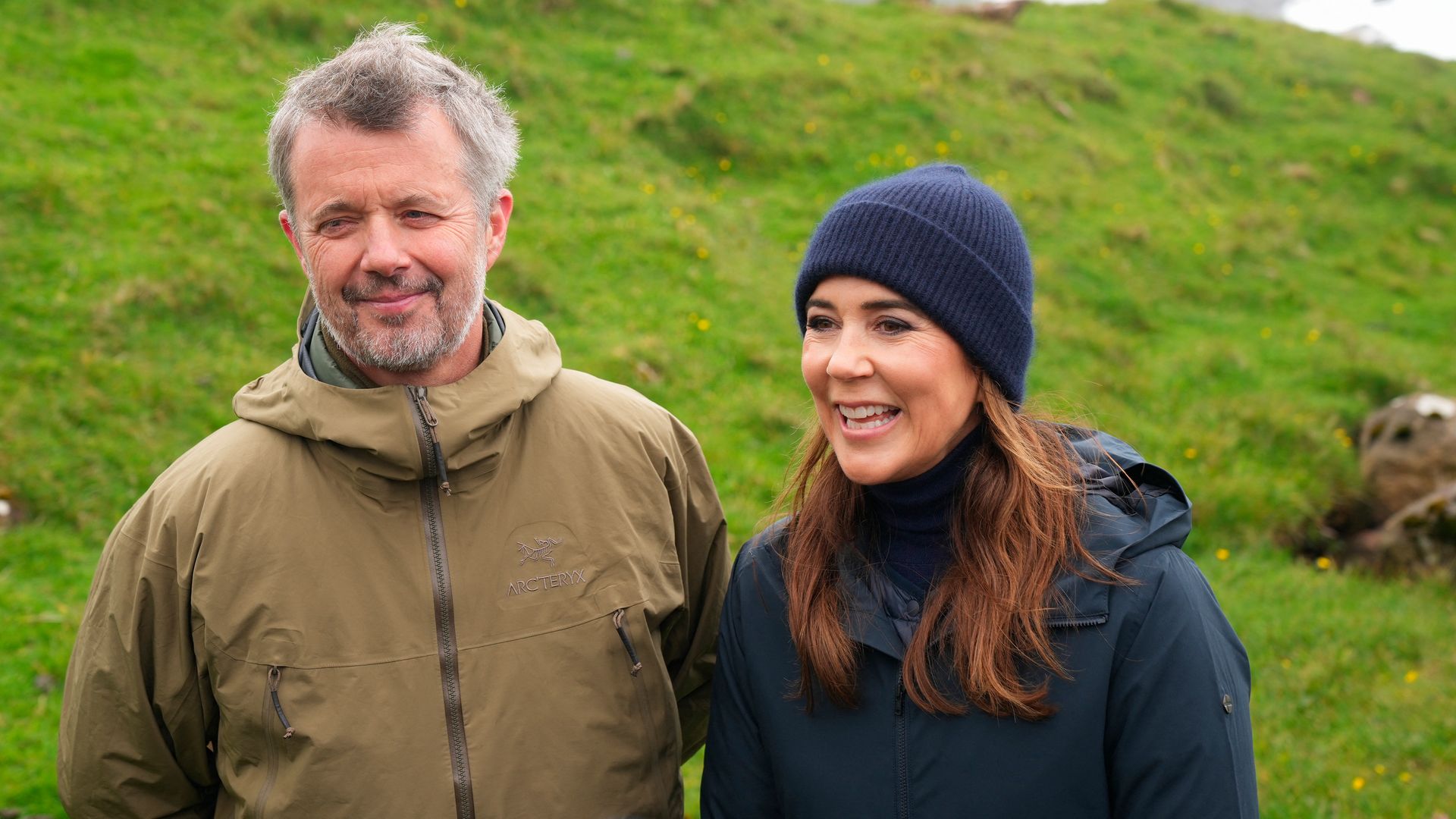 King Frederik and Queen Mary standing on Vagseidi mountainside on the island of Suduroy