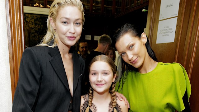 Harper stood between Gigi and Bella Hadid, wearing a black lace dress with braids. Her stylish yet innocent look perfectly complemented the models at the glamorous event.