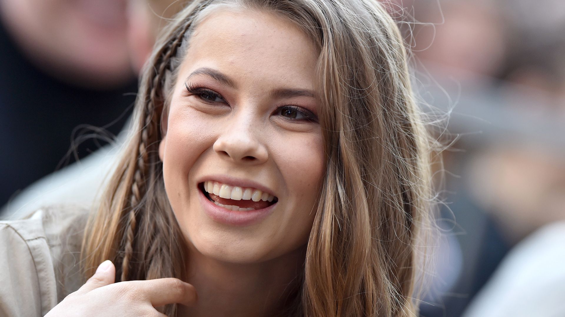 Bindi Irwin beamed at the camera wearing one small plait in her hair