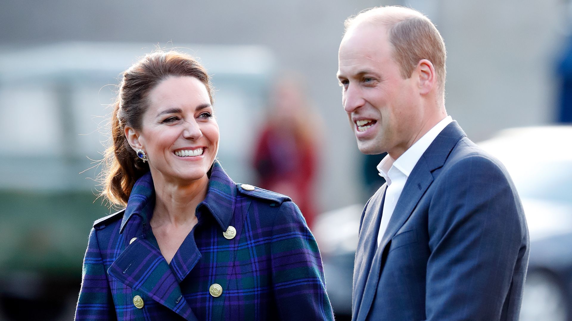 Kate in tartan coat smiling with William