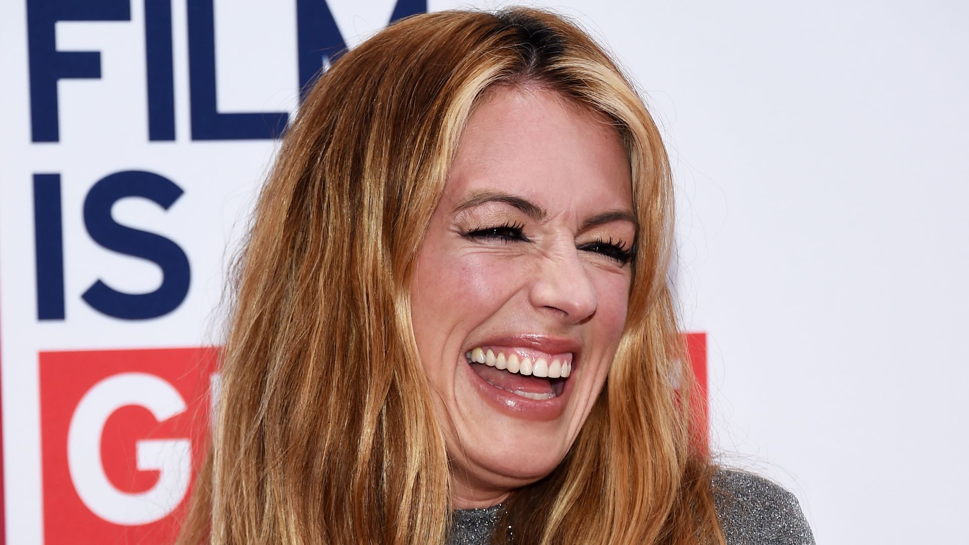 Cat Deeley laughing in sparkly jumper