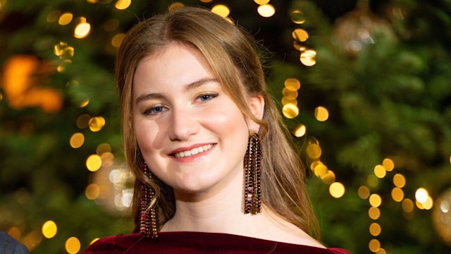 Princess Elisabeth wearing burgundy dress and gold eyeshadow