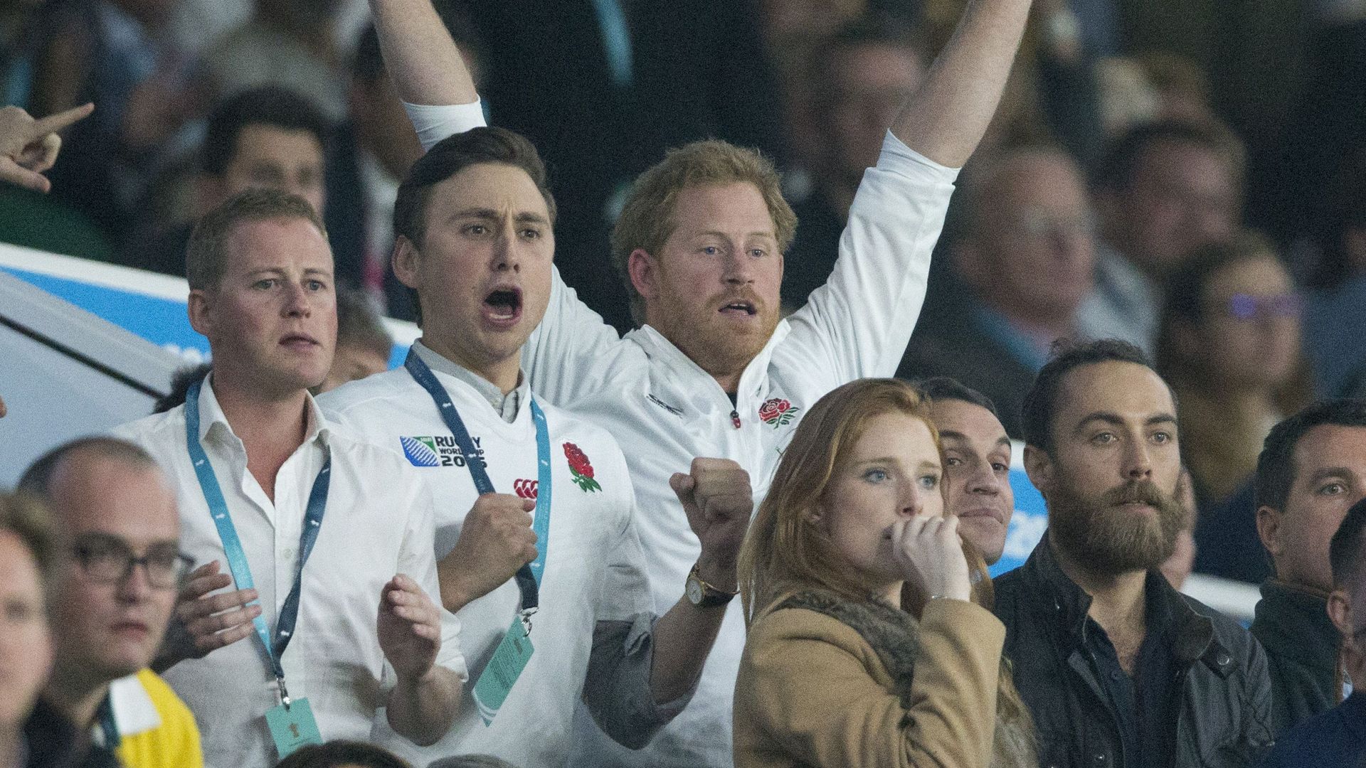 Charles Van Straubenzee and Prince Harry celebrating in the crowd of a rugby match