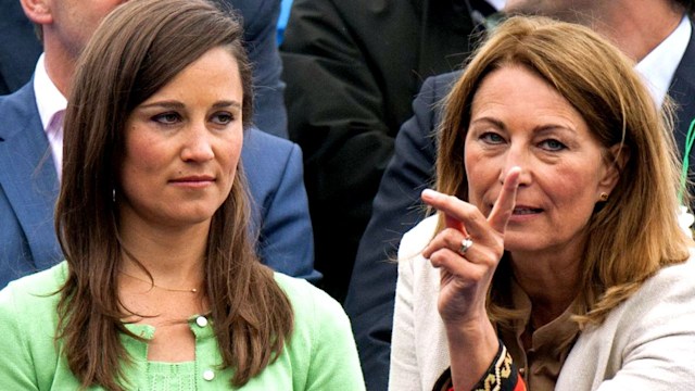Carole Middleton pointing as she speaks to Pippa Middleton in a green dress