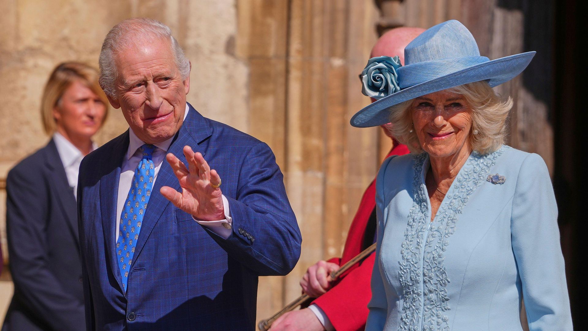King Charles III and Queen Camilla wave at the crowd as they arrive 