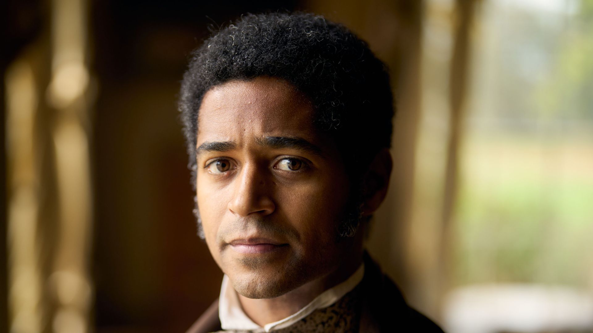 Man in period costume suit looking into camera