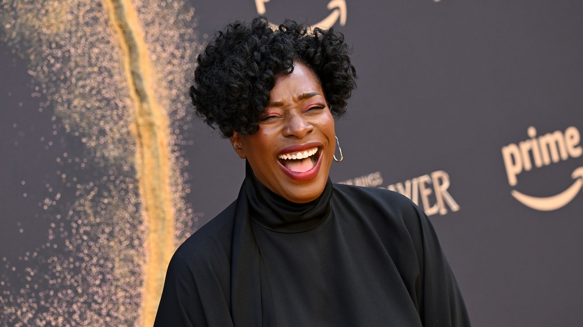 Tanya Moodie laughing on the red carpet at the rings of power premiere