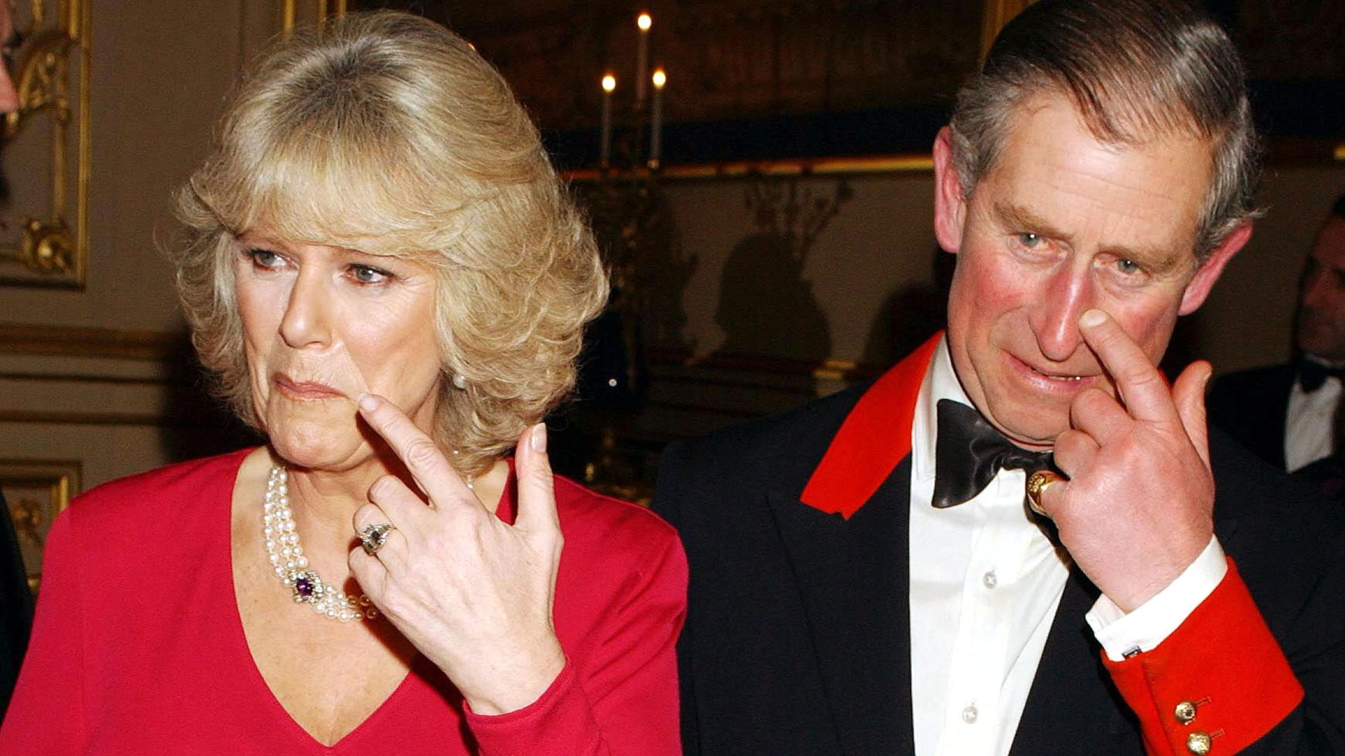 Queen Camilla wearing a red dress and her new engagement ring