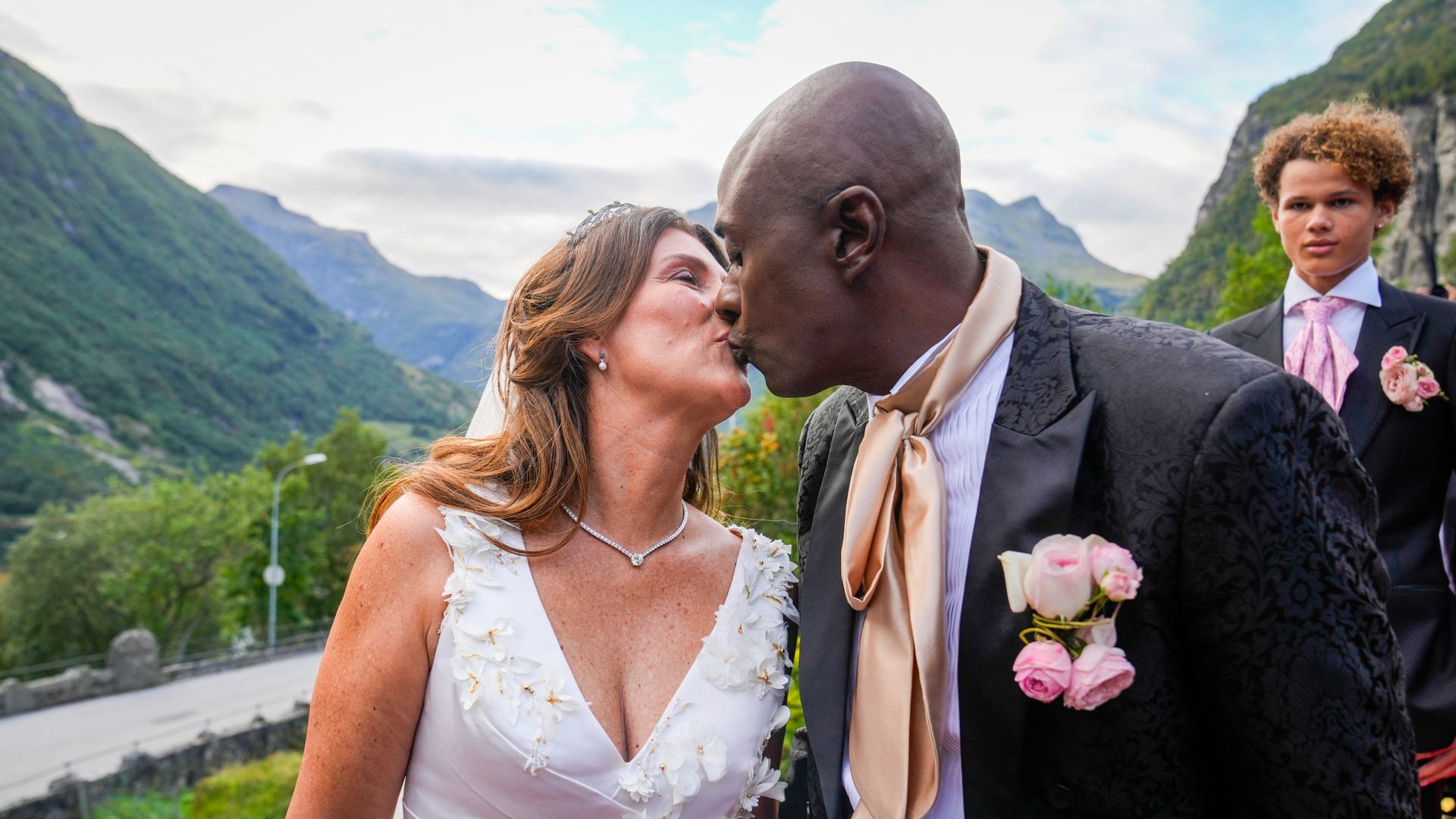 Princess Martha Louise of Norway and Durek Verrett kiss as they arrive at their wedding party at Hotel Unio in Geiranger