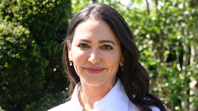 Lauren Silverman poses in white shirt dress