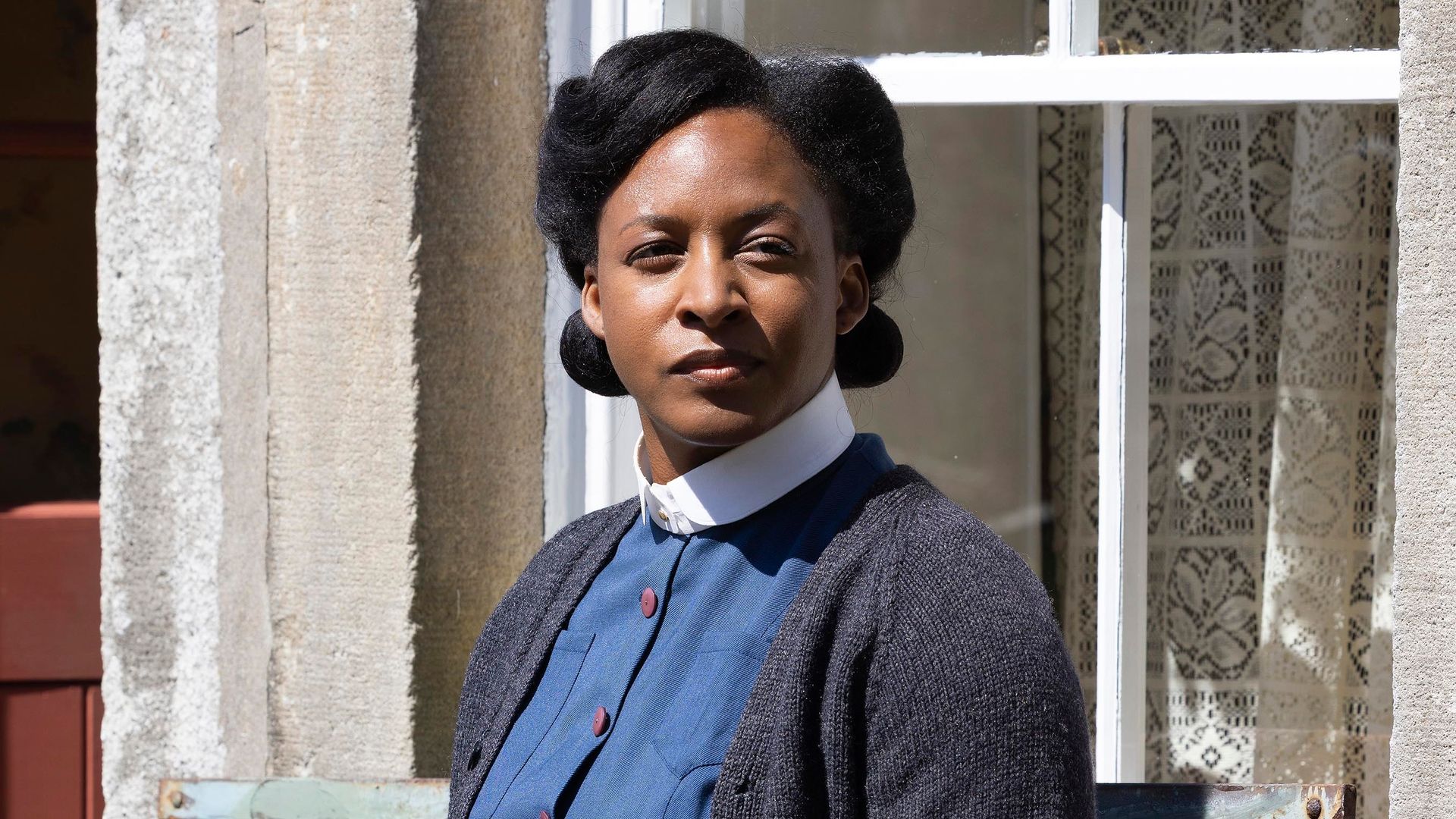 nurse sitting on bench outside house