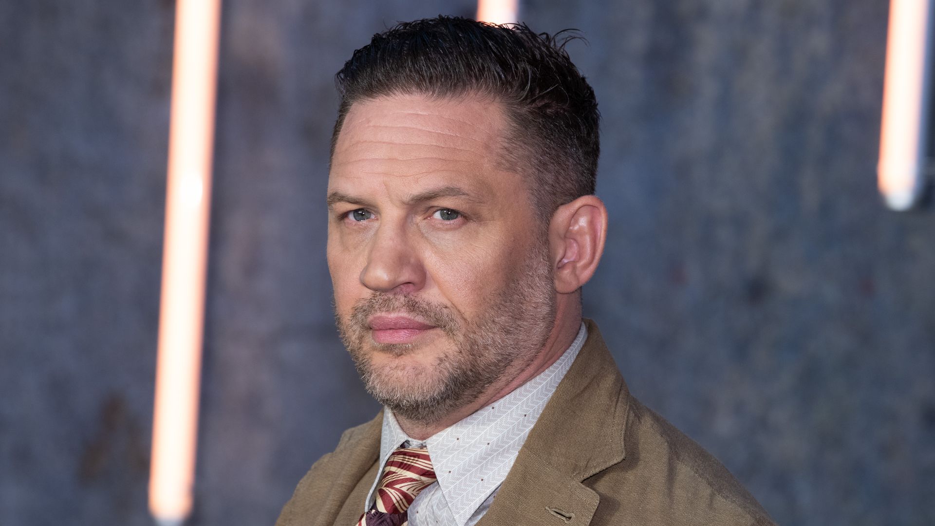 close-up actor in suit on red carpet