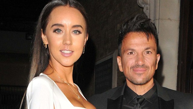 Emily MacDonagh in a white dress next to Peter Andre in a black suit