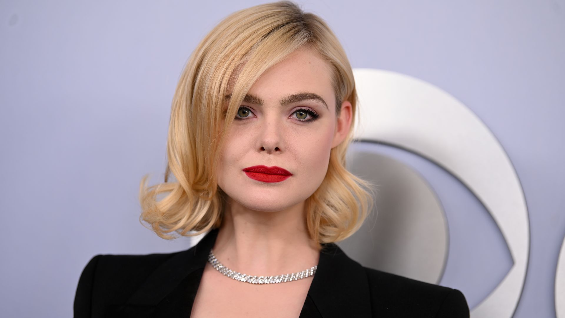 Elle Fanning's plunging suit and red lip is giving major SHE-E-O vibes