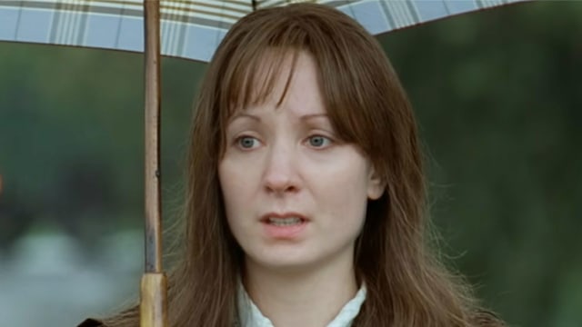 Brunette woman holding umbrella