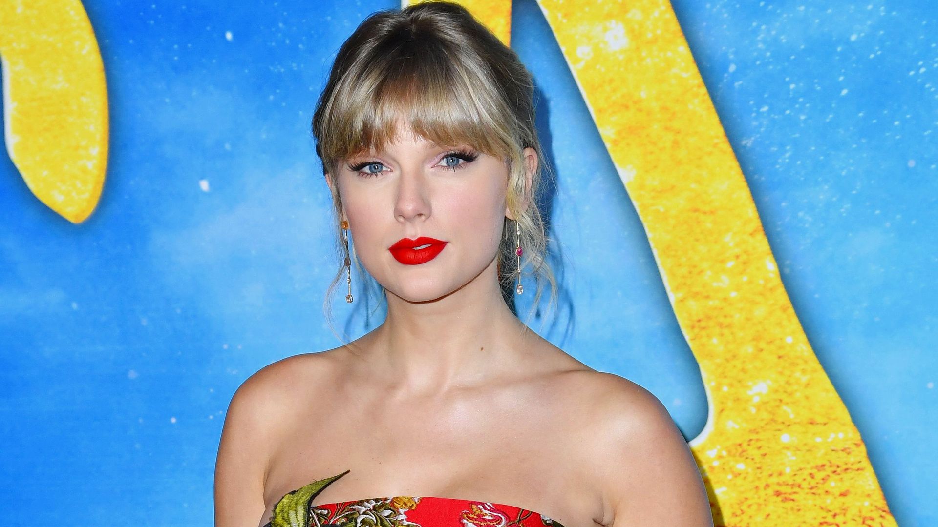 Taylor Swift in a red dress with floral design