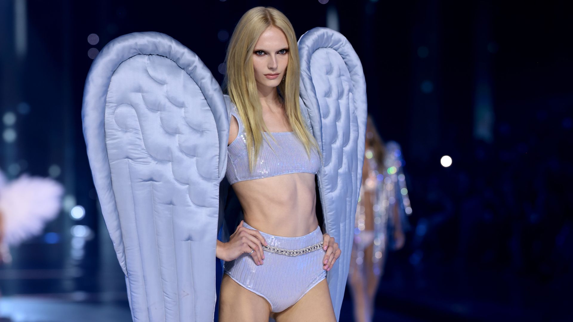 Alex Consani walks the runway for the Victoria's Secret Fashion Show 2024  in purple wings