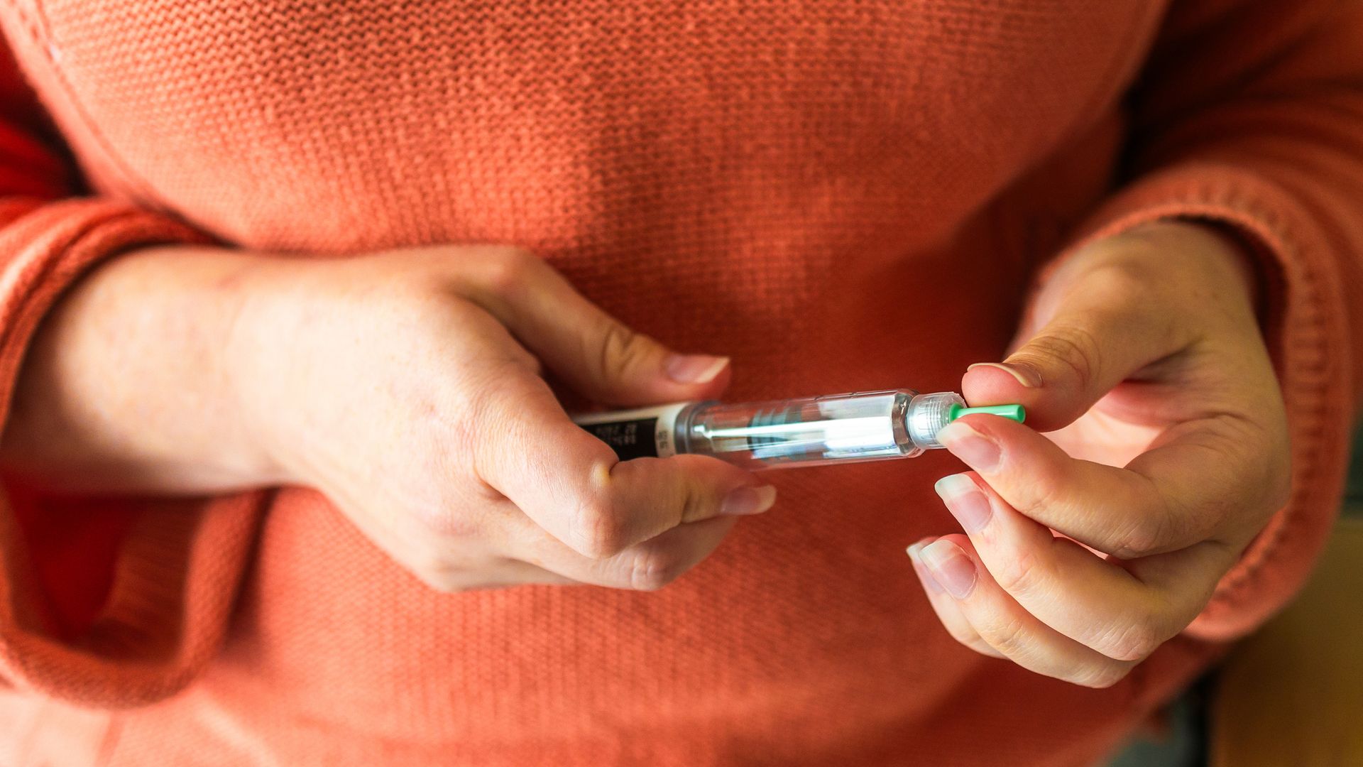 Woman preparing to administer weight loss injection