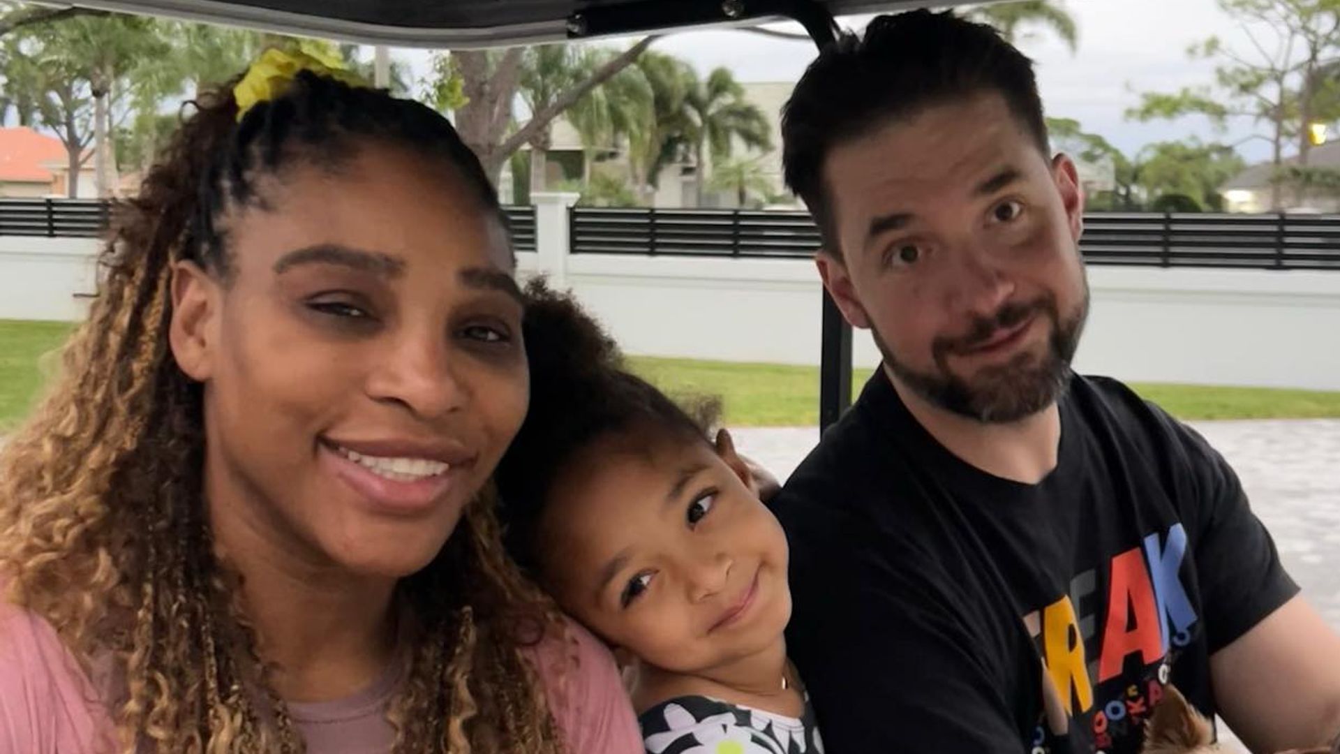 Serena in golf cart with daughter and husband