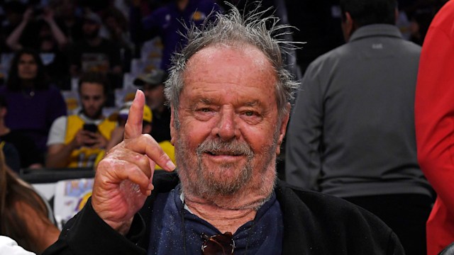 jack nicholson at basketball game with finger in the air