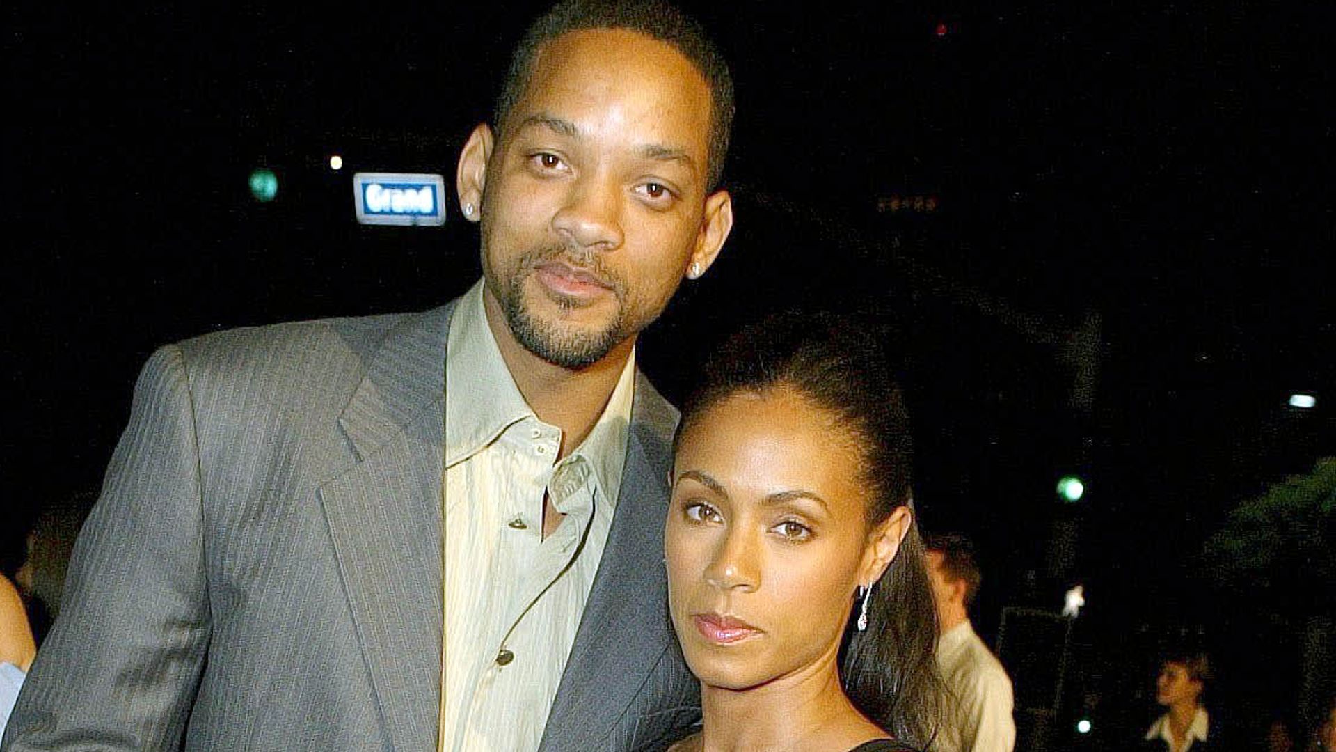 Will Smith in a suit and Jada Pinkett Smith in a black and white dress