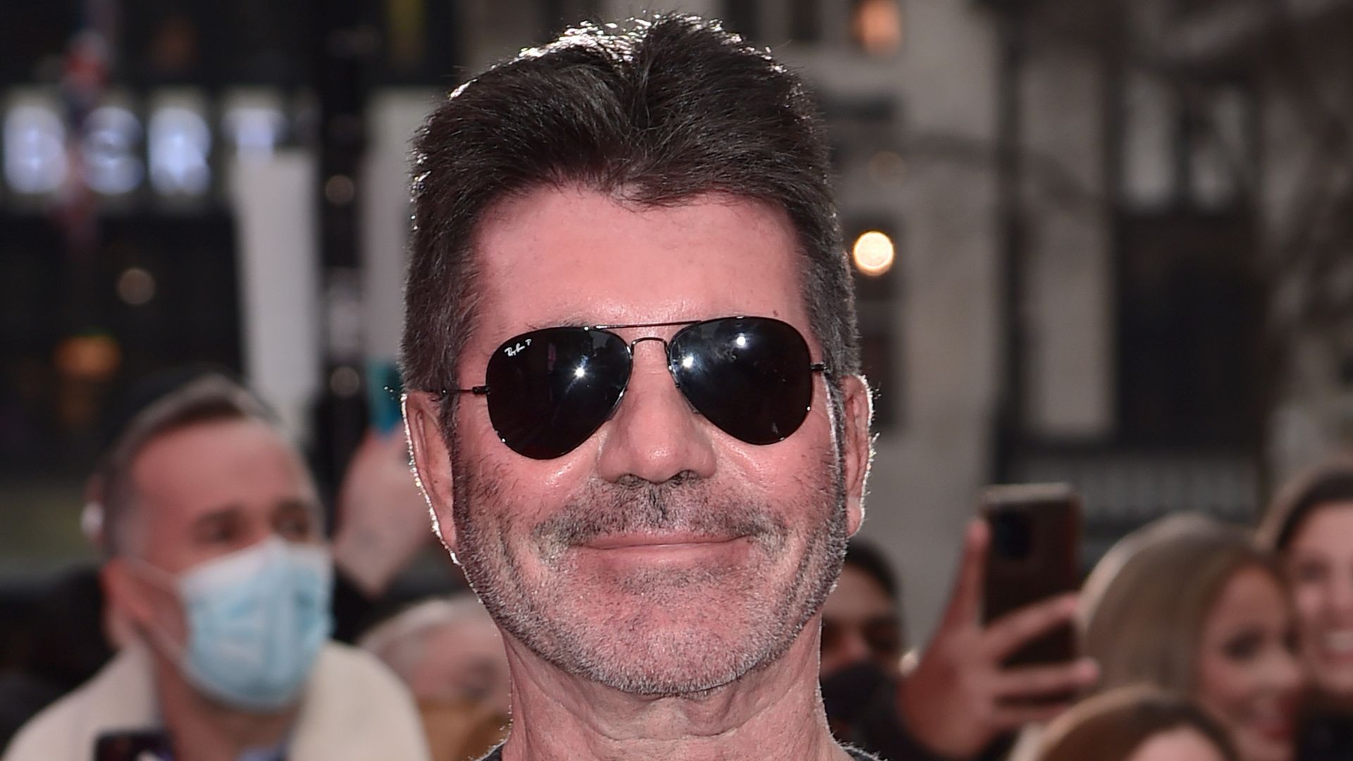 Simon Cowell in a grey jumper and sunglasses