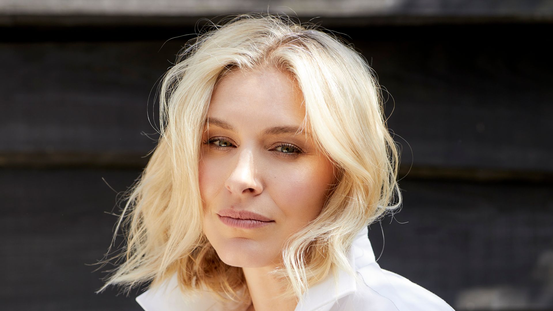 woman with blonde hair wearing a crisp white shirt 