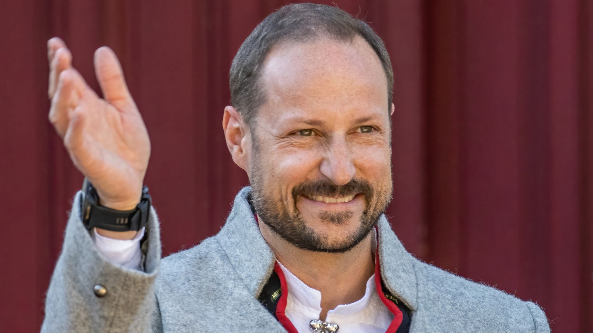 Crown Prince Haakon of Norway smiling and waving