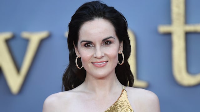 Michelle Dockery attends the World Premiere of 'Downton Abbey' at Leicester Square in 2019 wearing a gold dress