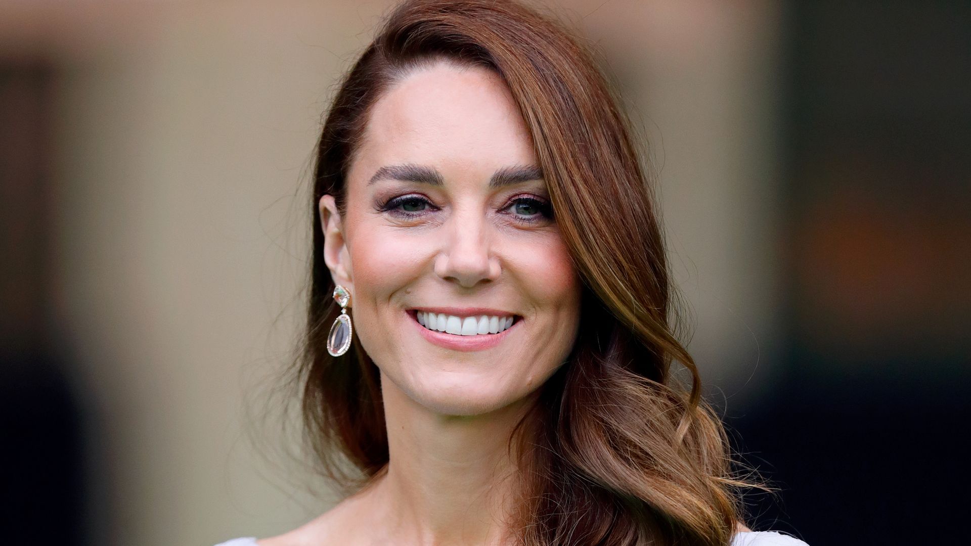 Catherine smiling with hair on one shoulder