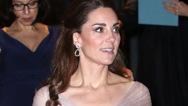 Princess Kate walks down stairs in a pink dress at a Gala Dinner in aid of Mentally Healthy Schools
