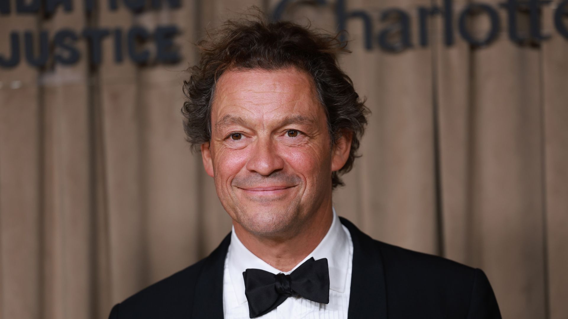 close-up of man in tuxedo posing for photo