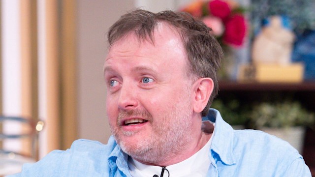 man sitting on sofa in blue shirt