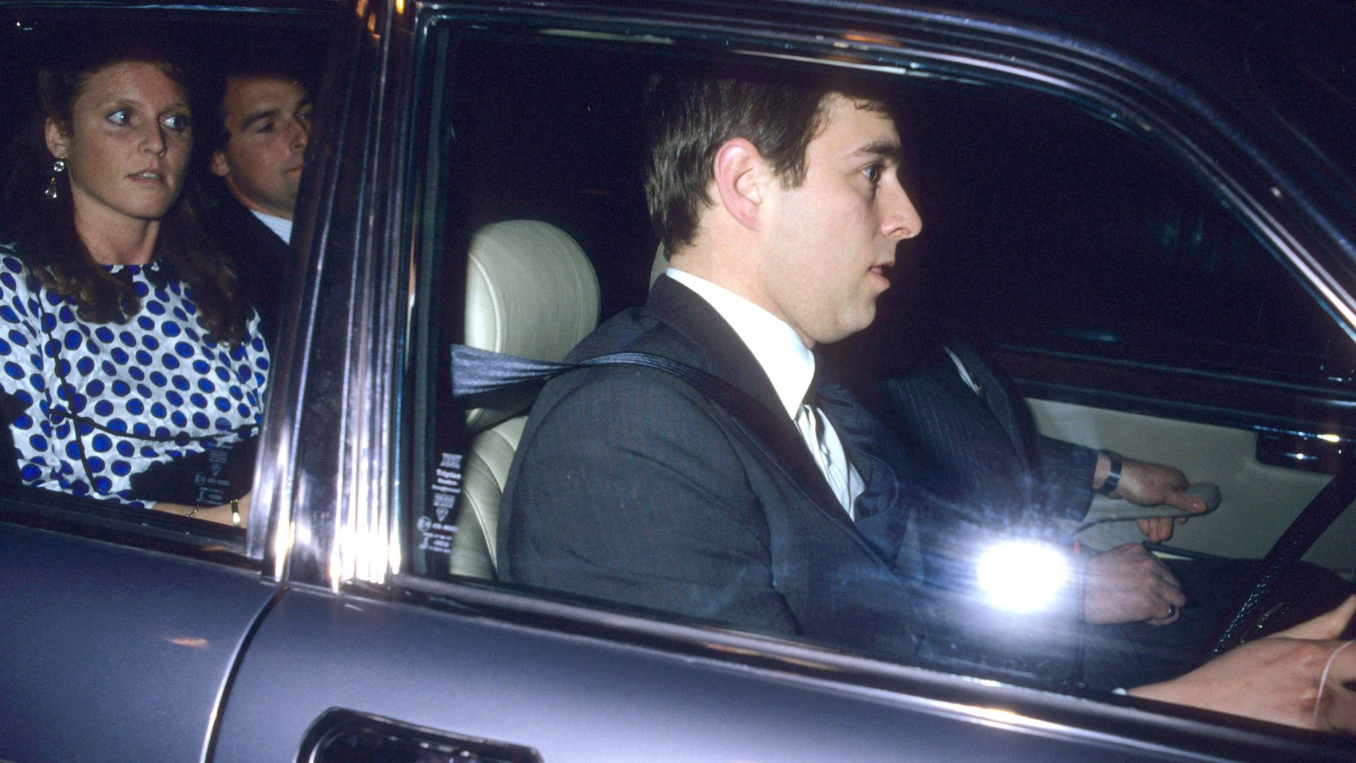 Prince Andrew driving a car with Sarah Ferguson in the back