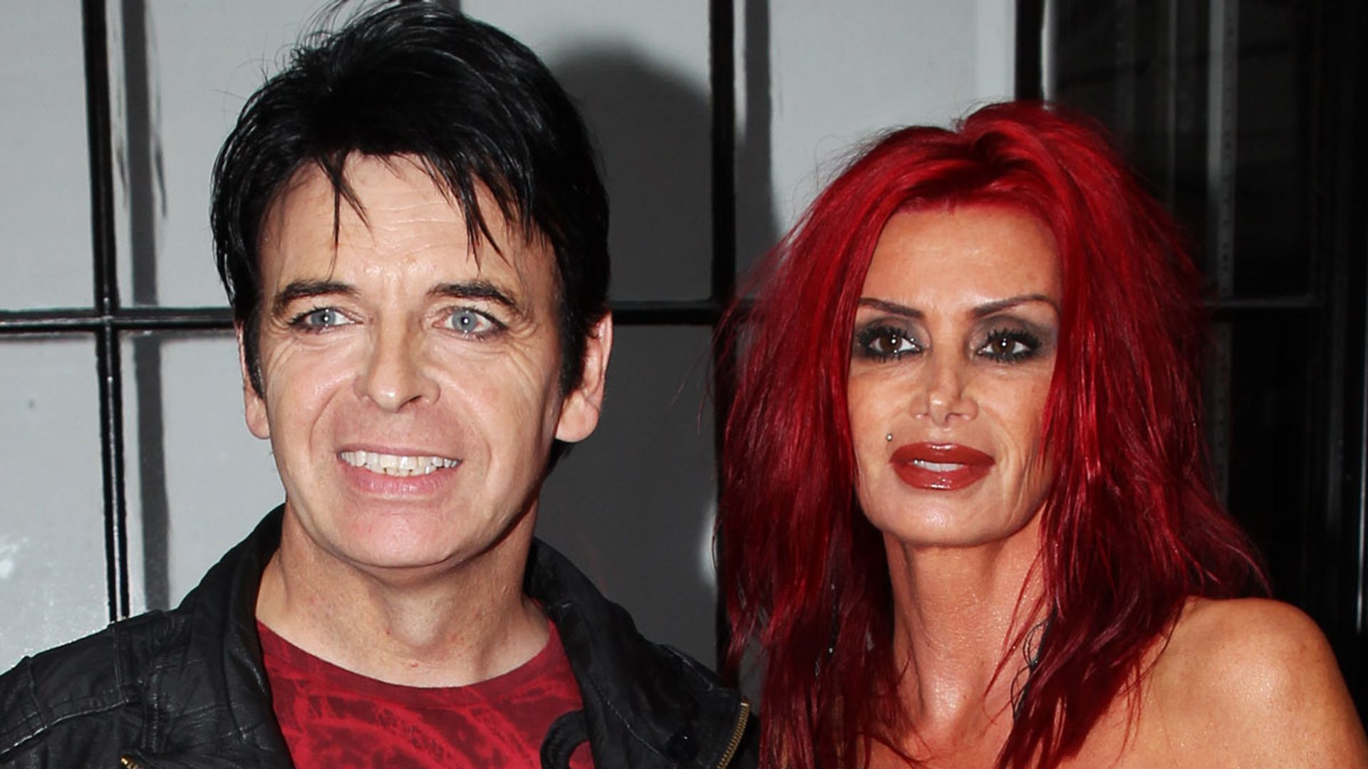 Gary Numan in a red T-shirt and Gemma Numan in a leopard print dress